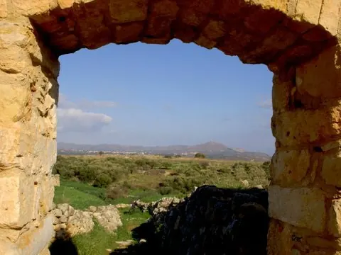 Mount Akrotiri seen through a stone archway