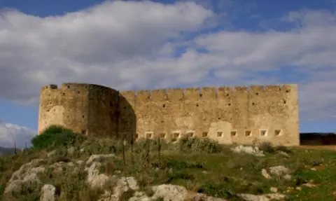 A long, low stone fortress on a grassy hill
