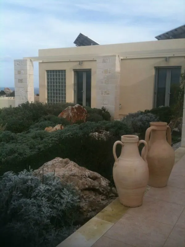 Guest rooms seen from the north-facing patio, with two tall clay pots