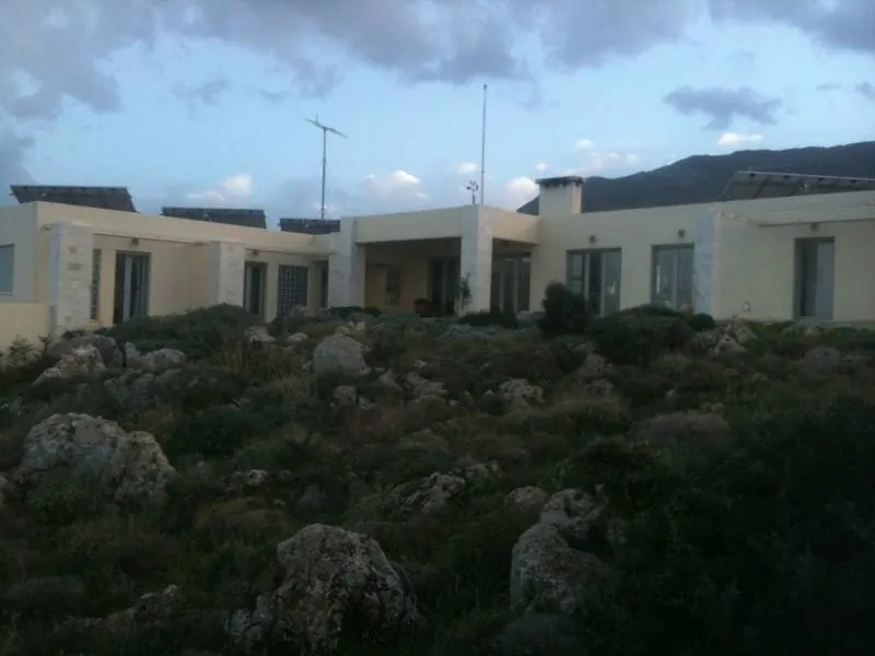 The house at dusk under a cloudy sky