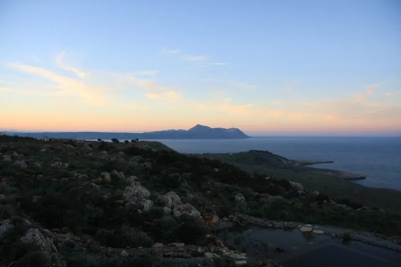 Sunset over the sea with the Akrotiri peninsula on the horizon