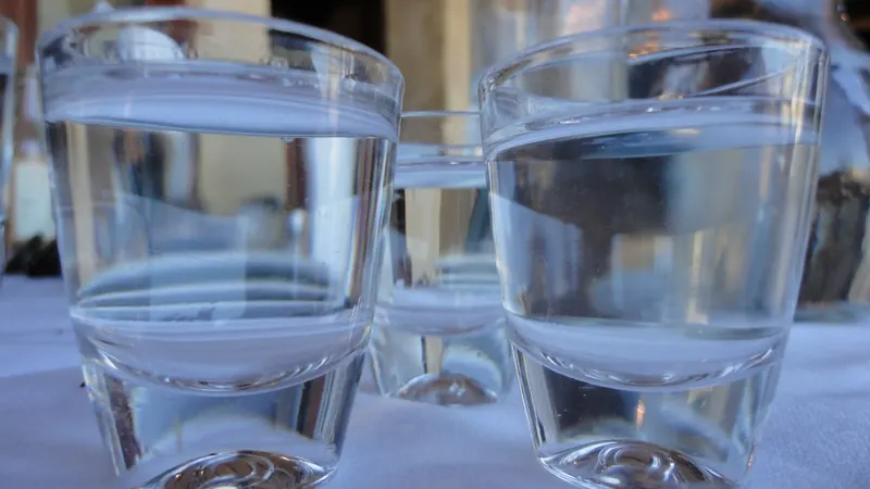Two glasses of water on a white tablecloth